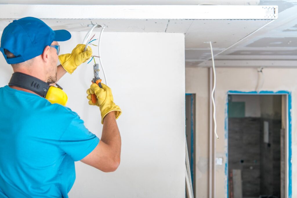 man fixing electric wirings